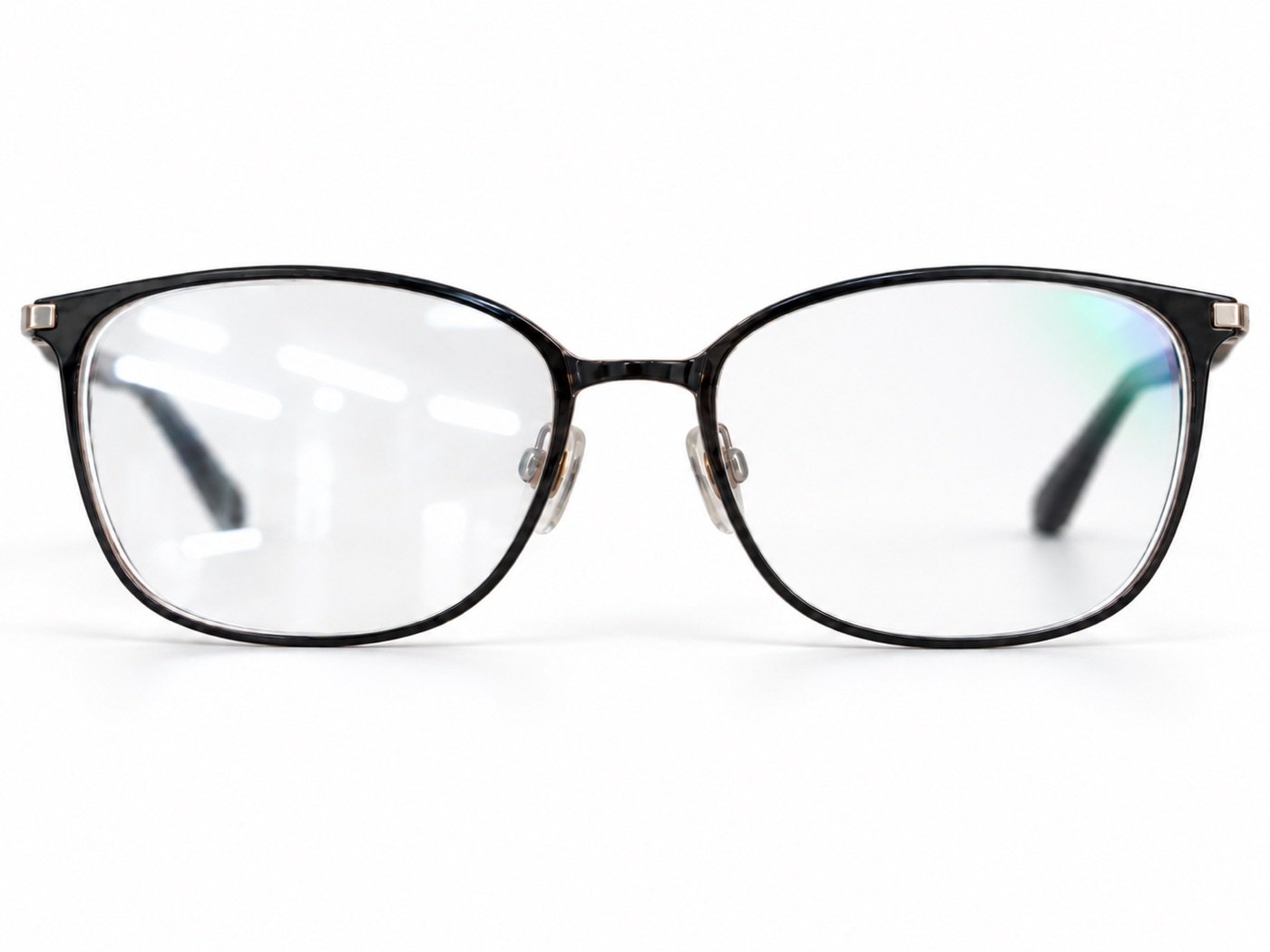 A pair of glasses with one lens throwing back bright white reflections and the other, anti-reflective coated, staying clear